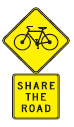 A sign telling drivers to share the road with bicyclists.